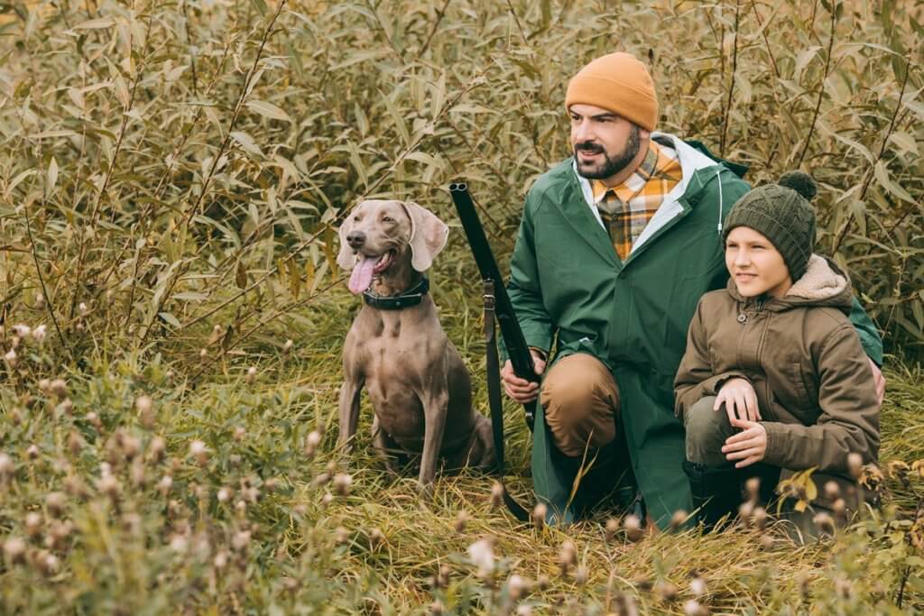 A father, son, and dog hunting
