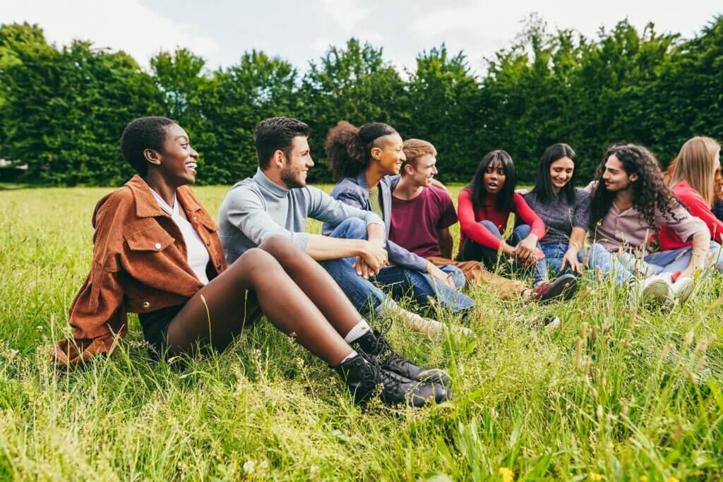 A college class sitting in a field