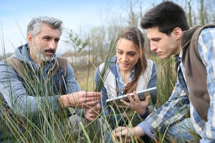 Students and a professor examining natural wildlife
