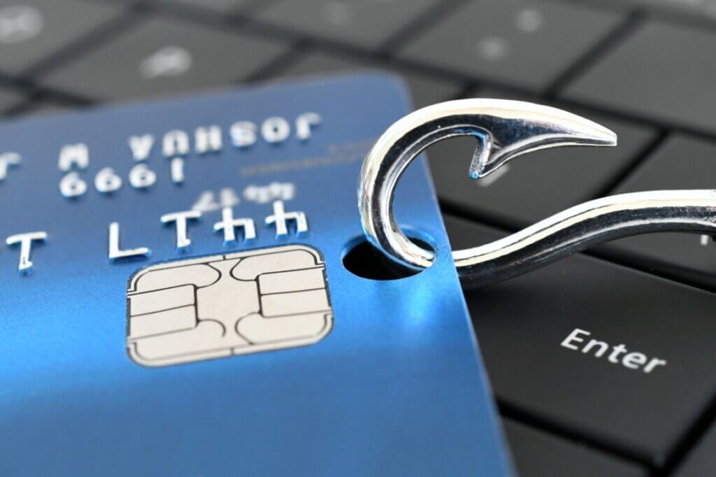 A fish hook snagged through a credit card
